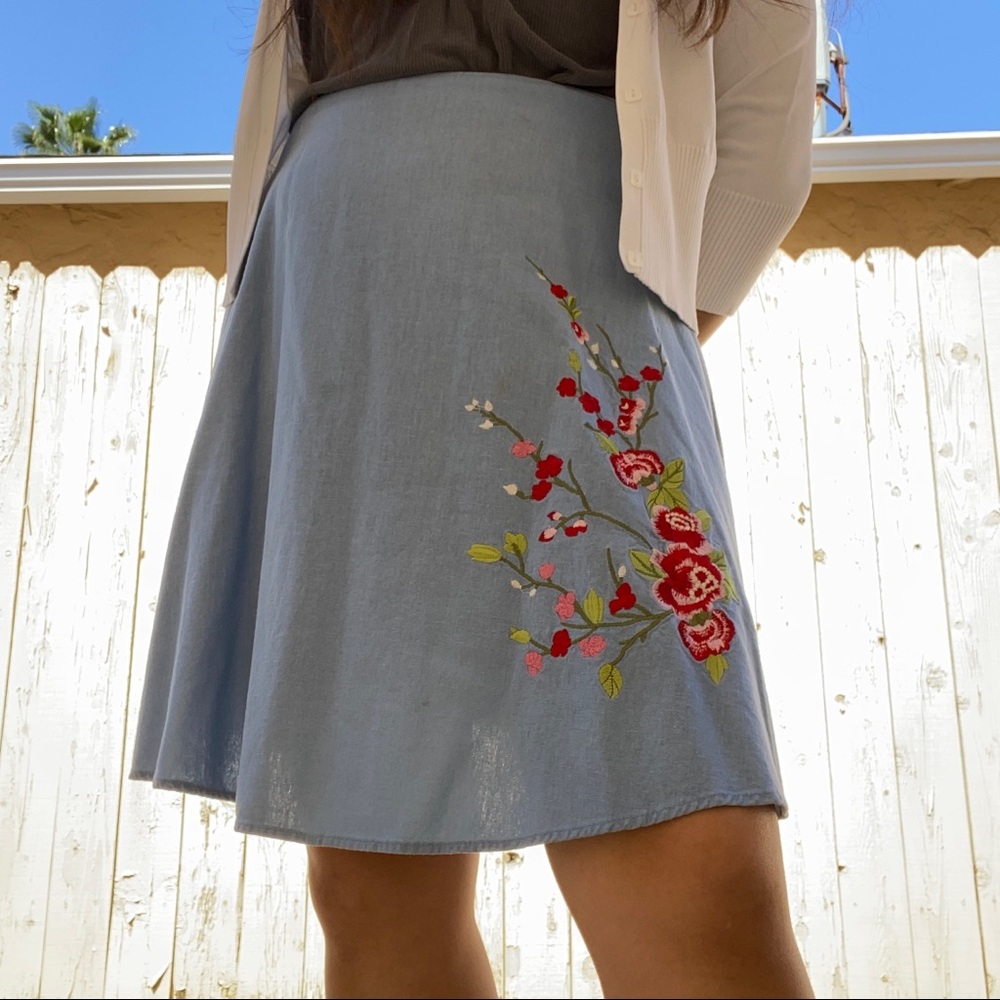 blue skirt with red flower embroidery